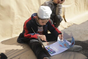 Samer*, 6, enjoying child-friendly activities run by a Save the Children local partner in northern Syria. His mother Nadia*, 23, says the earthquakes have impacted Samer’s mental health and well-being. Photo: Khalil Ashawi/Save the Children