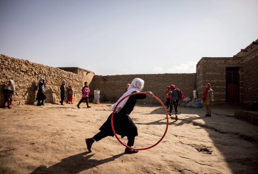 Girls play outside after their class at Save the Children’s Child Friendly Space in a displacement camp in Balkh province, Afghanistan