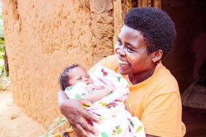 Sarah*, 31, with her third baby, born healthy due to a C-section. Photo credit: Thacien Biziyaremye/Save the Children. 