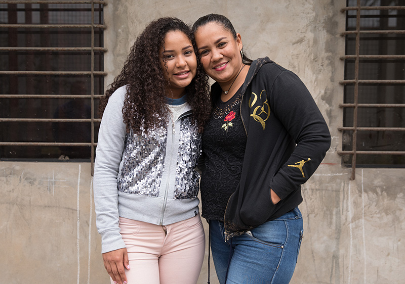 Rossi, 15, with her mother Mariana, 41, from Venezuela, stand outside their rented apartment in Lima, Peru